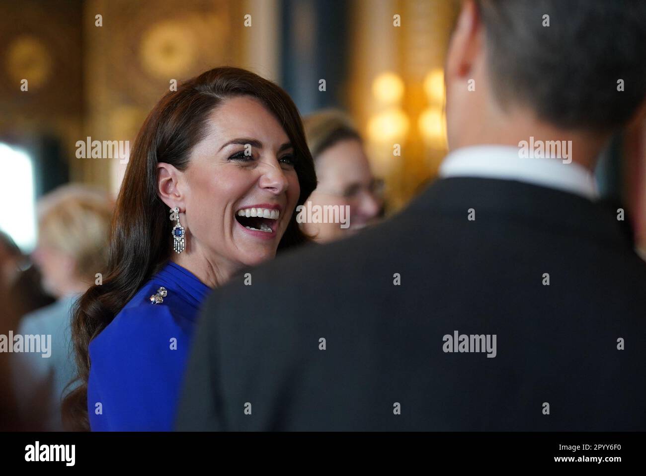 The Princess of Wales speaks talks to guests, during a reception at Buckingham Palace, in London, for overseas guests attending the coronation of King Charles III. Picture date: Friday May 5, 2023. Stock Photo