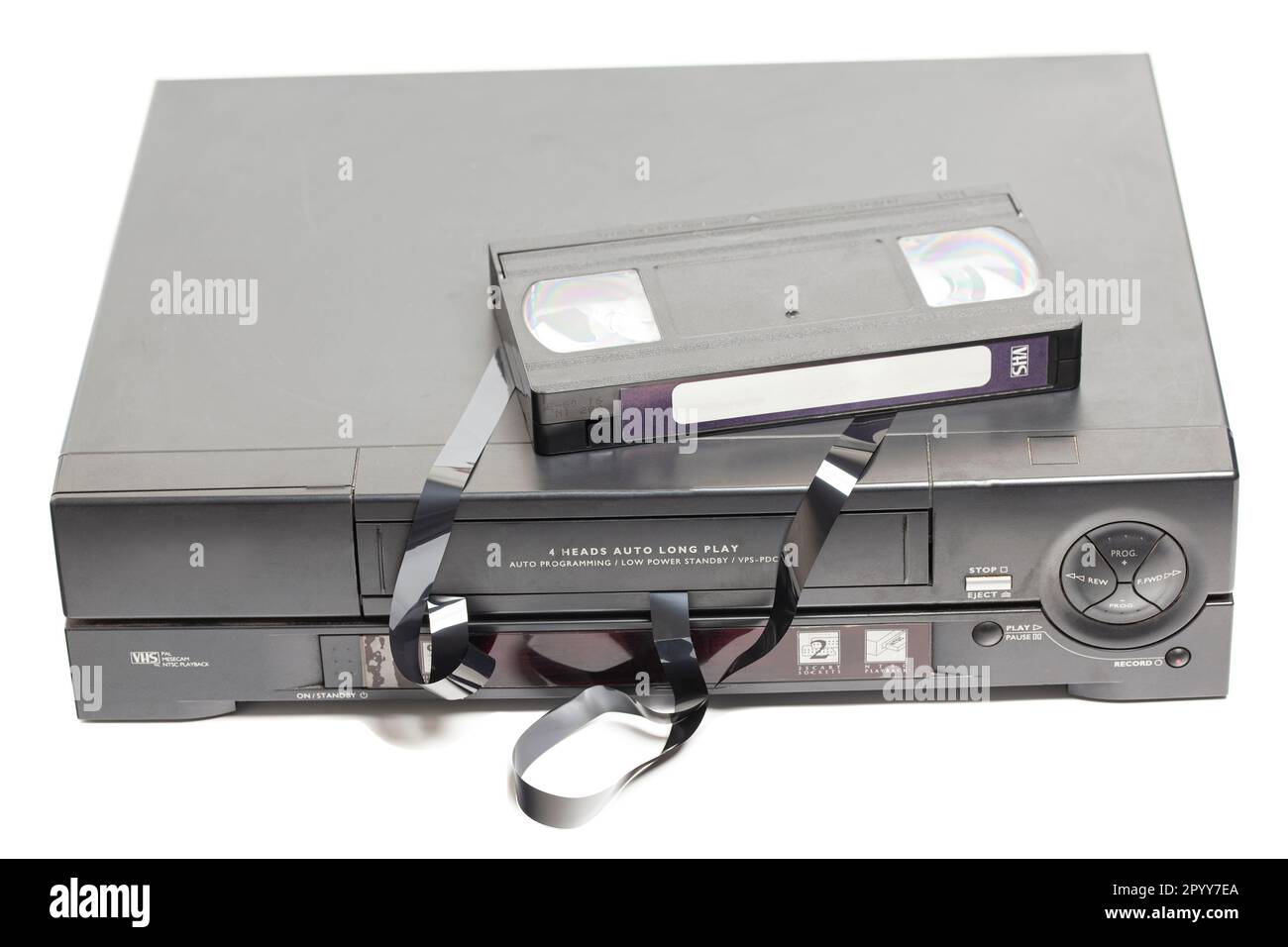 Two retro video cassette recorders with broken VHS cassette with unwound tape isolated on white