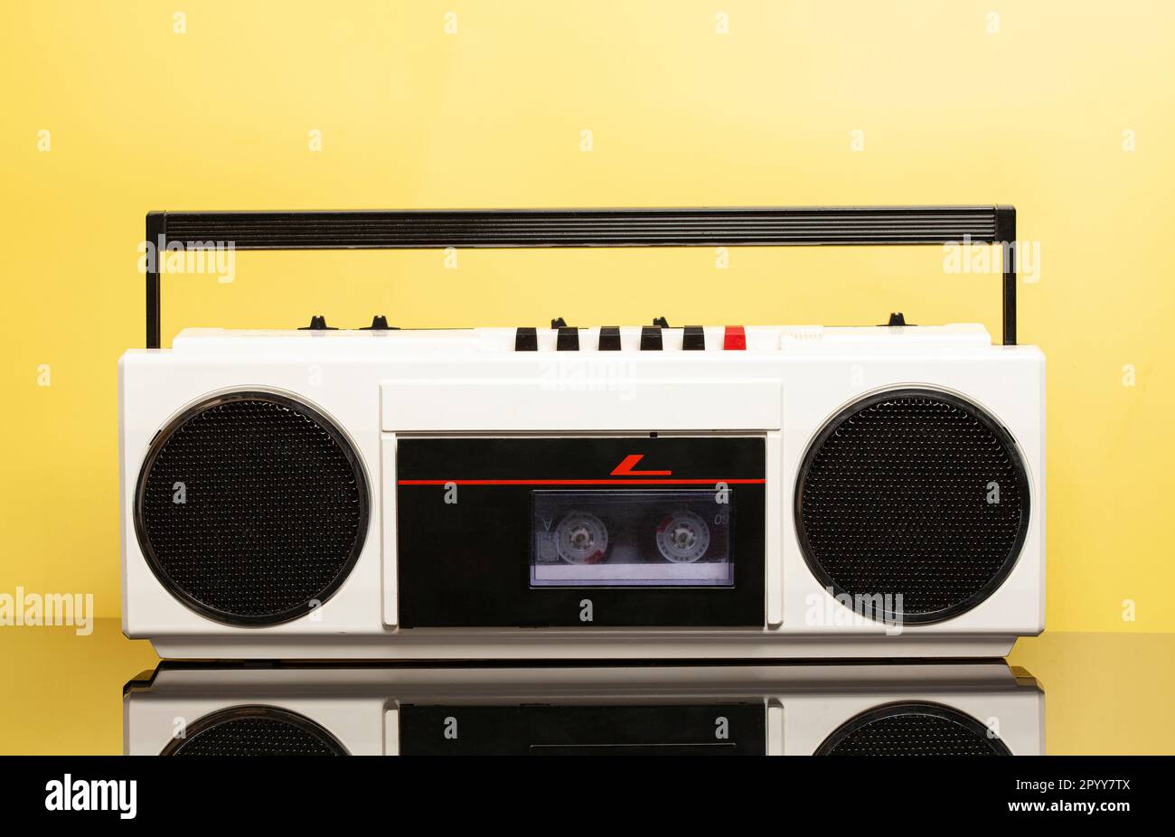 Retro portable stereo cassette recorder from 80s. on a yellow ...