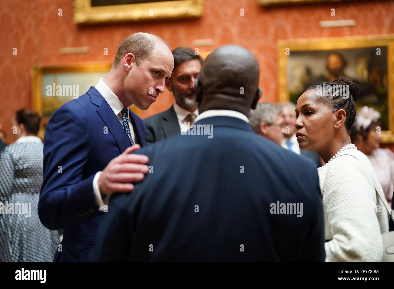 The Prince of Wales (left) speaks to guests during a reception at Buckingham Palace, in London, for overseas guests attending the coronation of King Charles III. Picture date: Friday May 5, 2023. Stock Photo