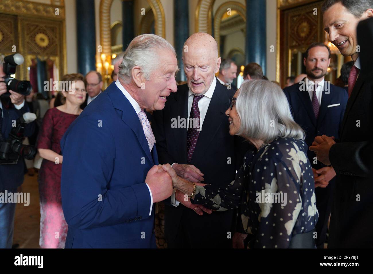 King Charles III (left) speaks to guests during a reception at Buckingham Palace, in London, for overseas guests attending his coronation. Picture date: Friday May 5, 2023. Stock Photo