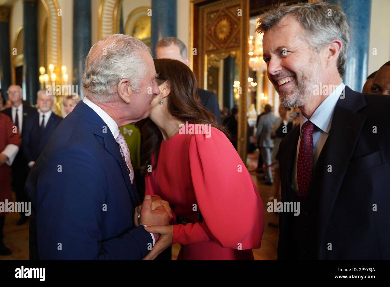 King Charles III (left) greets Mary, Crown Princess of Denmark and Crown Prince Frederik of Denmark, during a reception at Buckingham Palace, in London, for overseas guests attending his coronation. Picture date: Friday May 5, 2023. Stock Photo