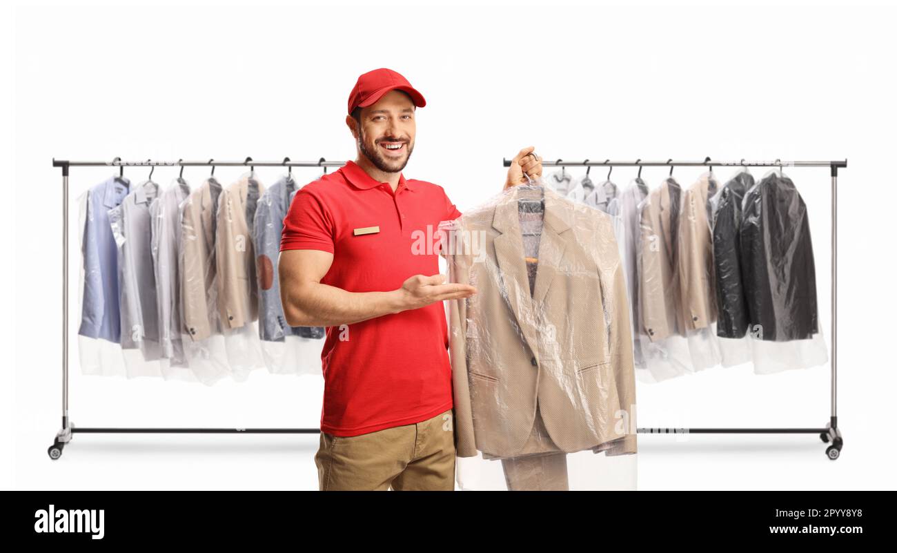 Male worker showing a suit at dry cleaners in front of racks with hanging clothes isolated on a white background Stock Photo