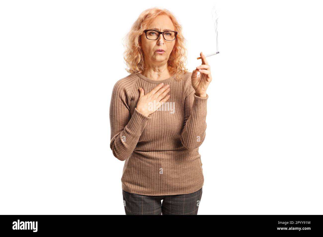 coughing and smoking cigarettes Mature woman coughing and smoking a cigarette isolated on white background  Stock Photo