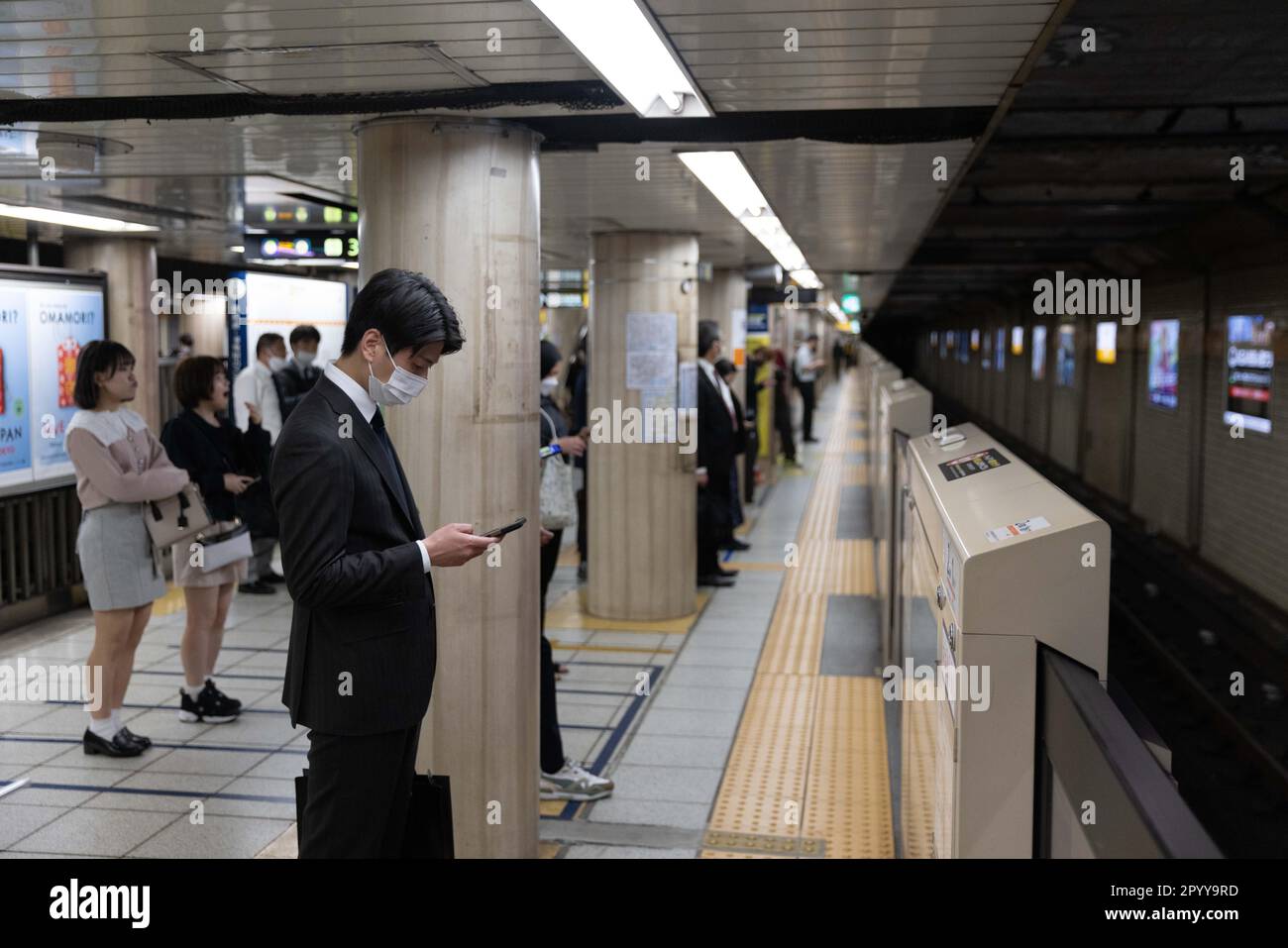 Tokyo, Japan. 02nd May, 2023. Japanese business man looks at his phone while waiting for a train in Shinbashi station. (Photo by Stanislav Kogiku/SOPA Images/Sipa USA) Credit: Sipa USA/Alamy Live News Stock Photo