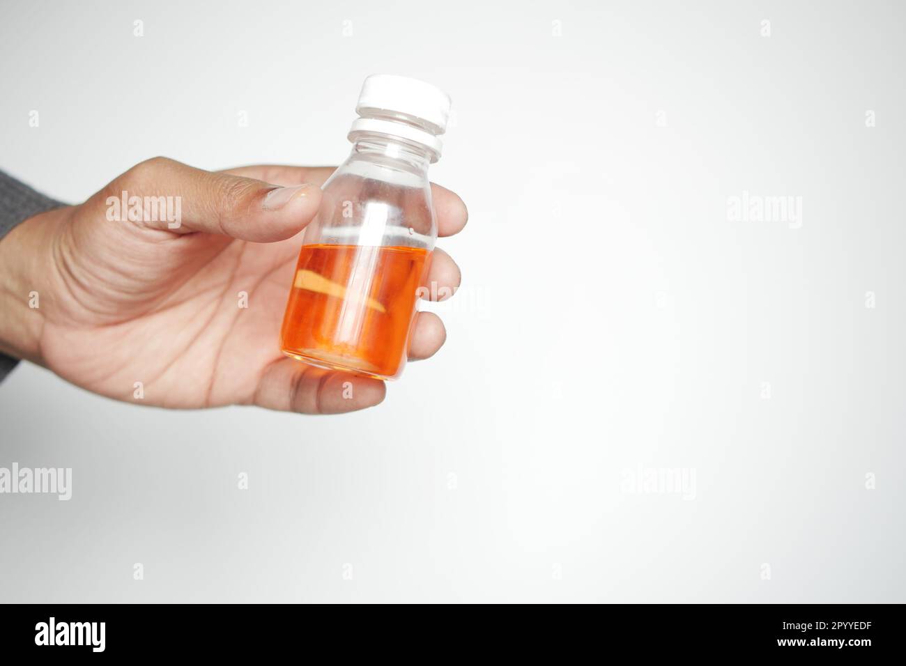 holding a antipyretic syrup bottle Stock Photo Alamy
