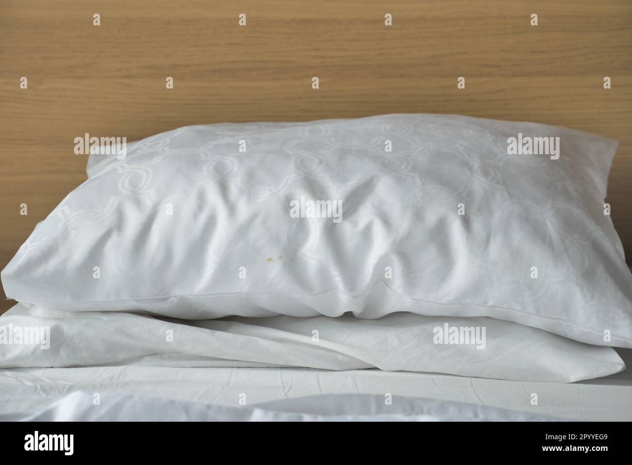 white pillow lined up on bed  Stock Photo