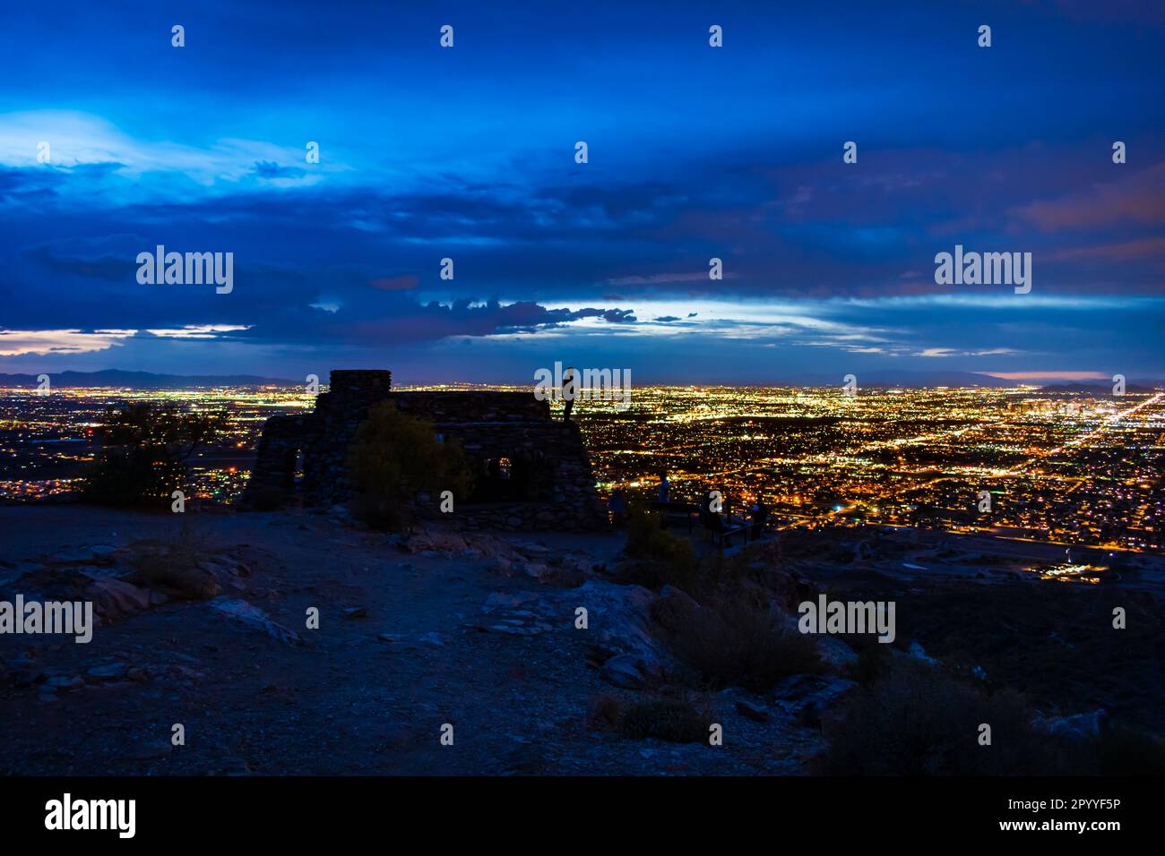 Night photograph of the silhouette of a man standing on the roof of