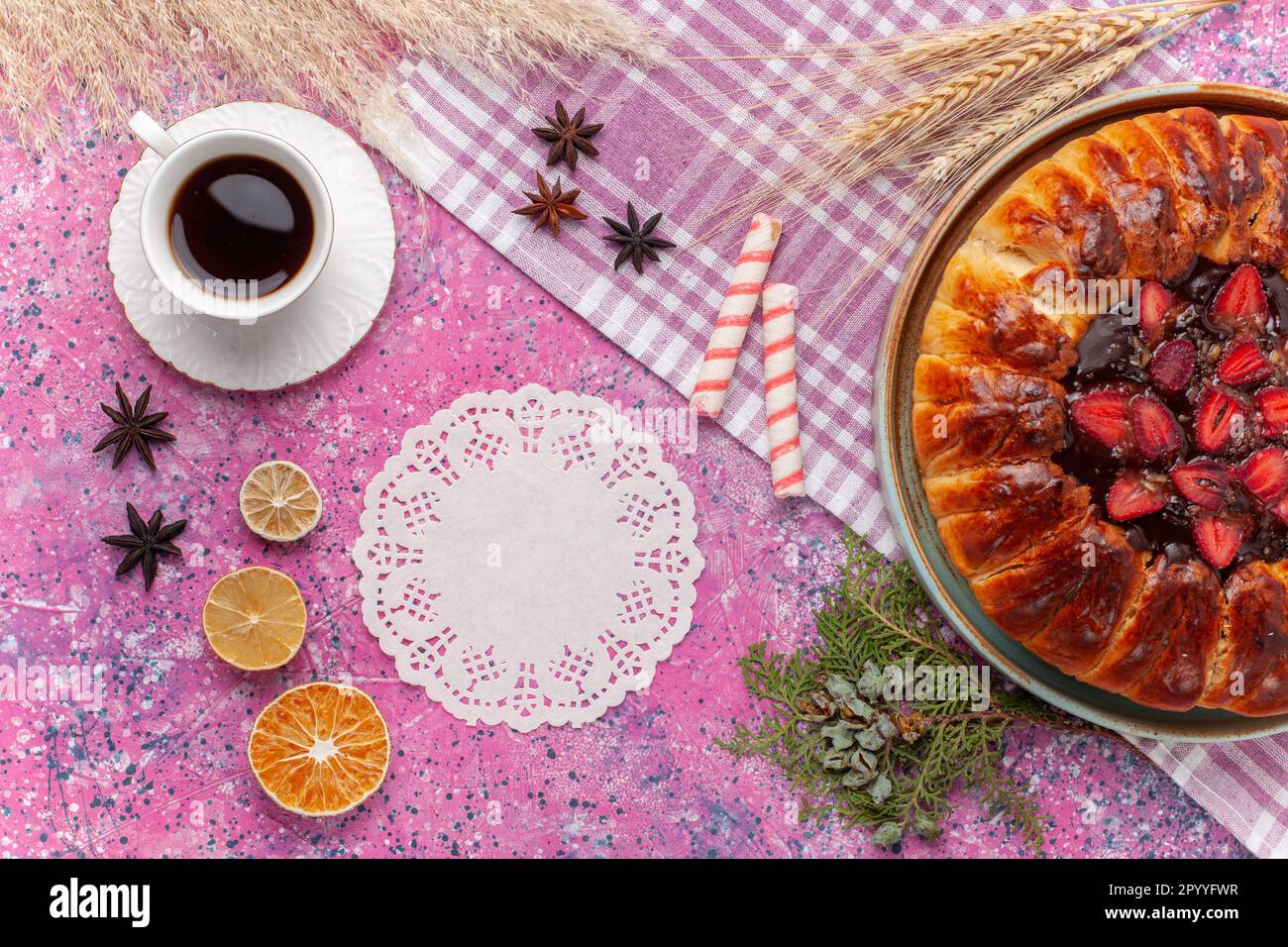 top view delicious strawberry pie fruity cake with cup of tea on pink background sweet pie cookie sugar cake tea biscuit dough fruit Stock Photo
