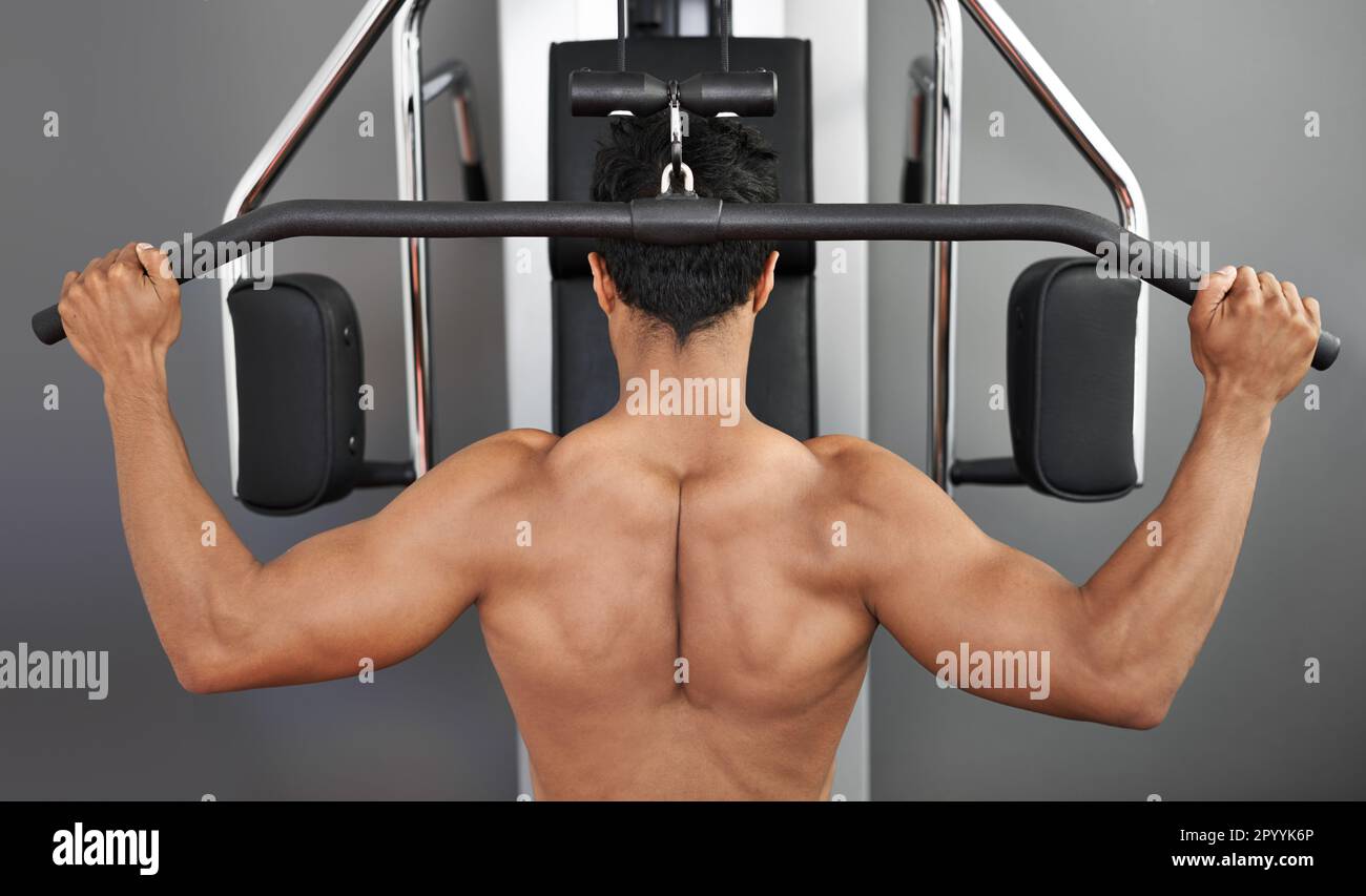 Striving for full body fitness. Rear view of a young ethnic man working ...