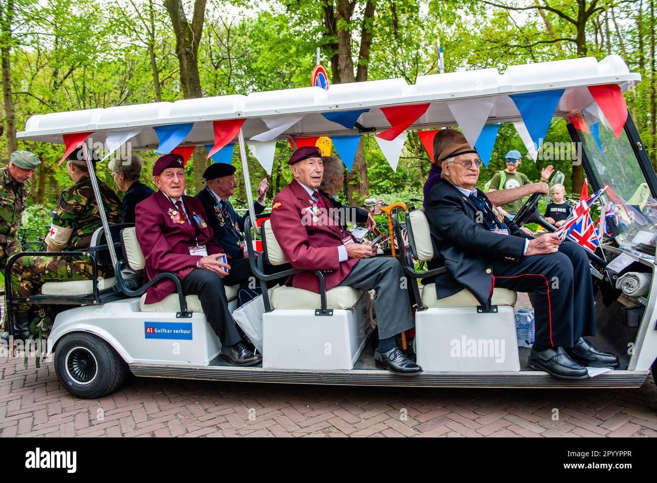 WWII English veterans are seen arriving in special cars. Wageningen, also known as the 'City of Liberation', is especially connected to the remembrance days here on 4 and 5 May, as the capitulation which ended World War II in the Netherlands was signed in the city. During Liberation Day, The Liberation Parade, or 'Bevrijdingsdefilé' in Dutch is celebrated each year and reunites veterans and military successors to pay tribute to all those who gave their lives during WWII. This year also 17 British veterans were warmly welcomed, they arrived in British black cabs. Stock Photo