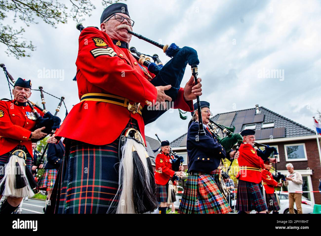 A music band is seen playing bagpipes during the parade. Wageningen