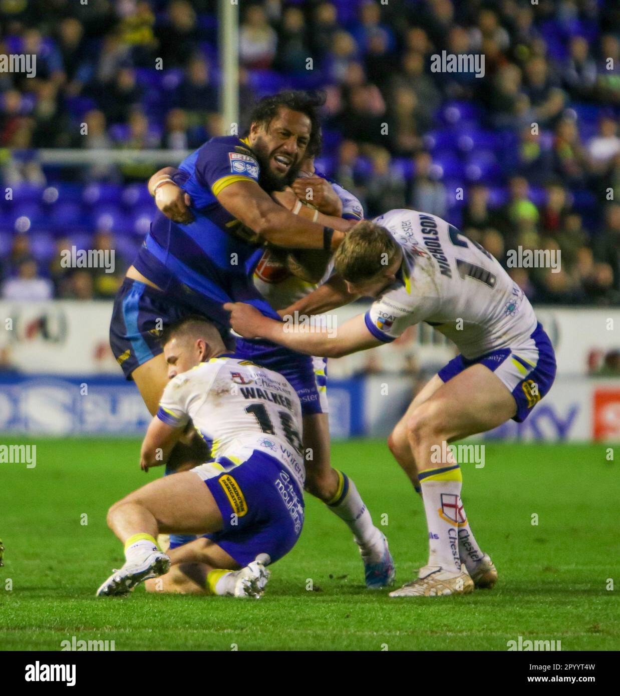 Warrington, Cheshire, England 5th May 2023. Wakefield Trinity’s Jorge Taufua tacked by Warrington Wolves’ Danny Walker and Marty Nicholson, during Warrington Wolves V Wakefield Trinity , at the Halliwell Jones Stadium, in the Betfred Super League Stock Photo