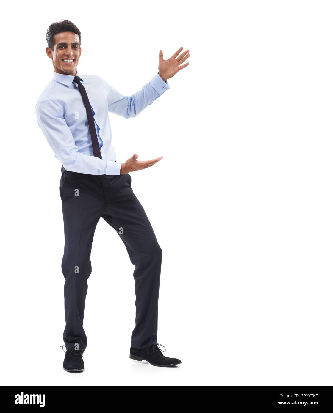 This is your space. Portrait of a handsome young businessman gesturing towards the copy space and smiling. Stock Photo