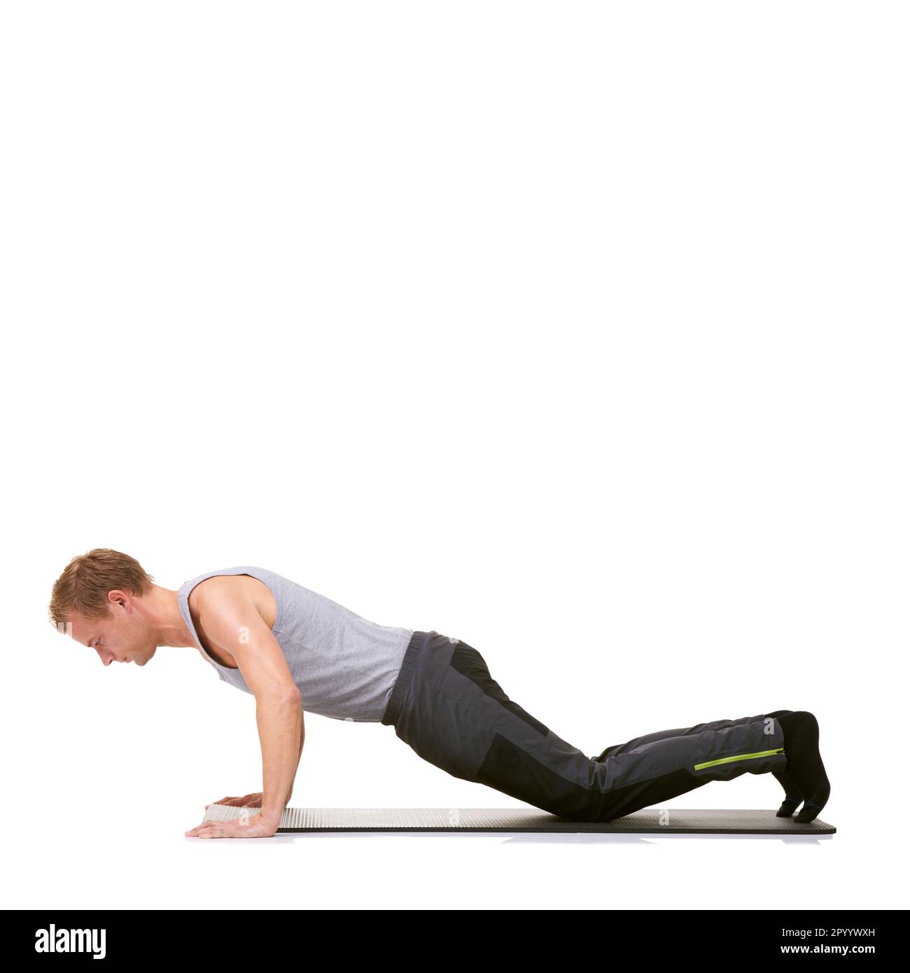 Perfecting his workout technique. A fit young man working out on his ...
