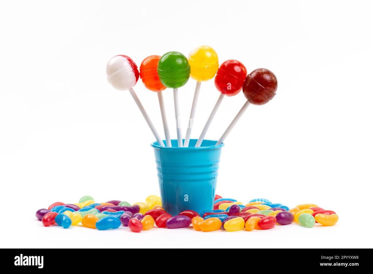 a front view lollipops inside bucket along with multicolored marmalades on the white desk sugar