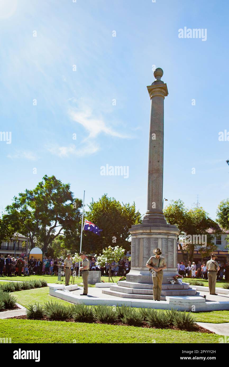 Soldiers standing around war memorial cenotaph in Burdekin Park during