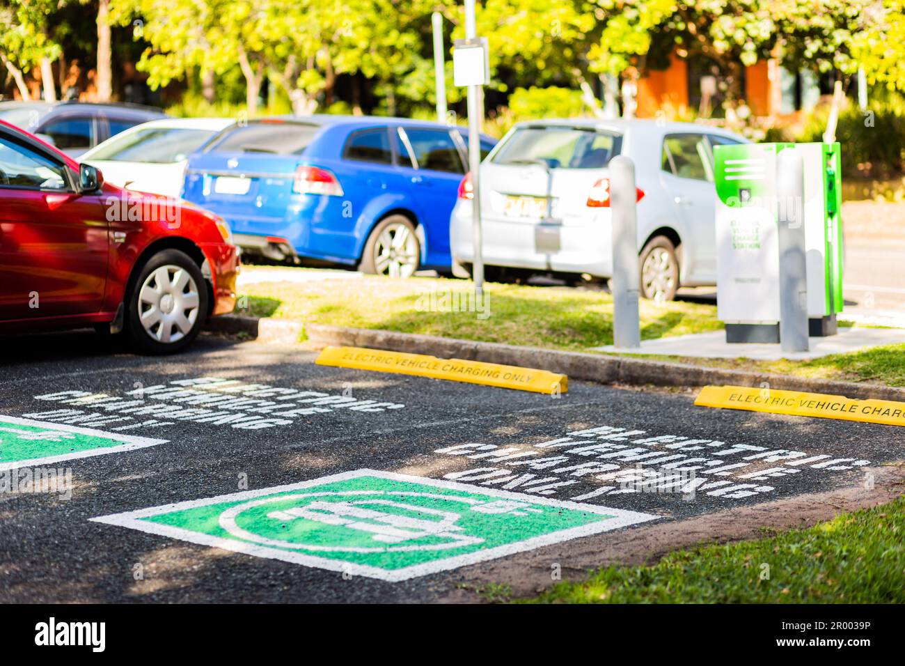 Electric charging only car park sign on road in car parking space in