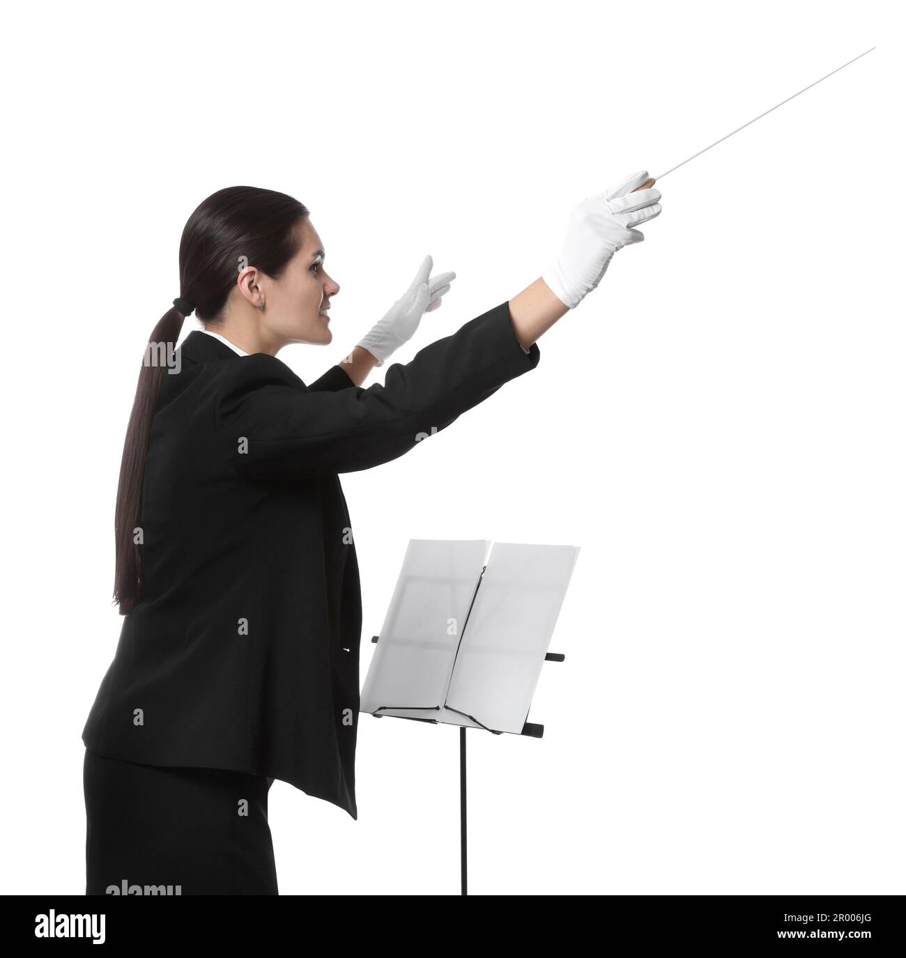Professional conductor with baton and note stand on white background