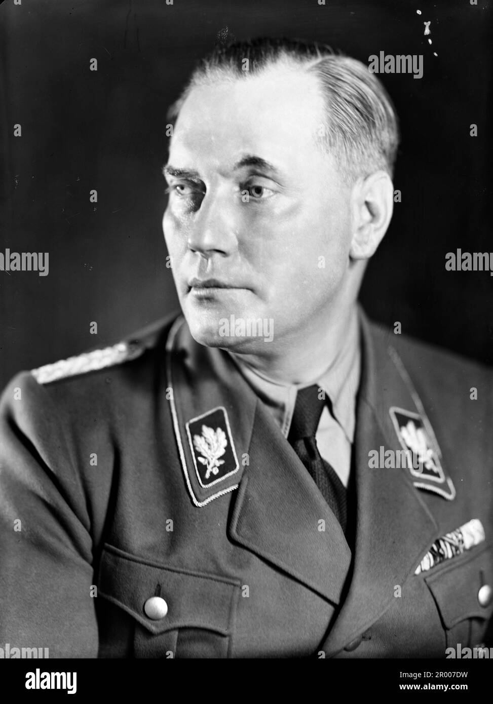 Wilhelm Brückner (11 December 1884 – 18 August 1954) was Adolf Hitler's chief adjutant until October 1940. Thereafter, Brückner joined the army, becoming an Oberst (colonel) by the end of World War II. In late 1922 he joined the Nazi Party . On 9 November 1923 Brückner took part in the Beer Hall Putsch in Munich, and was found guilty of aiding and abetting high treason. Brückner was appointed Chief Adjutant to Hitler on 20 February 1934, and retained that role until being dismissed on 18 October 1940. Here he is wearing his SA (Sturmabteilung) uniform in 1933–1934; Stock Photo