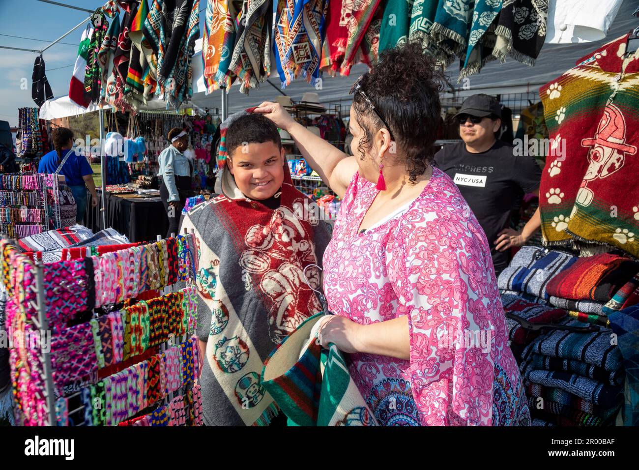 Detroit, Michigan, USA. 5th May, 2023. A boy tries on a serape on sale during the celebration of the Cinco de Mayo holiday in the Mexican-American community. Credit: Jim West/Alamy Live News Stock Photo