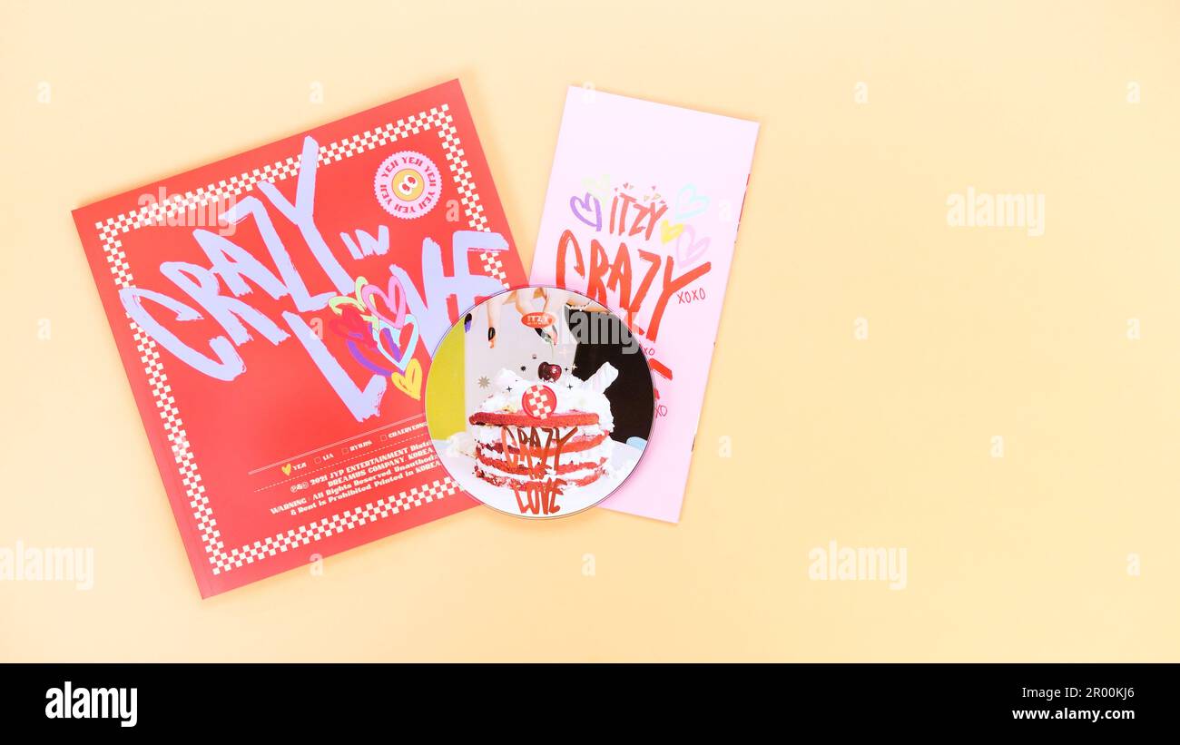 K-pop group Itzy CRAZY IN LOVE 1st Album on yellow background. Special edition music CD. South Korean girl group Itzy. Space for text. Gatineau, QC Ca Stock Photo