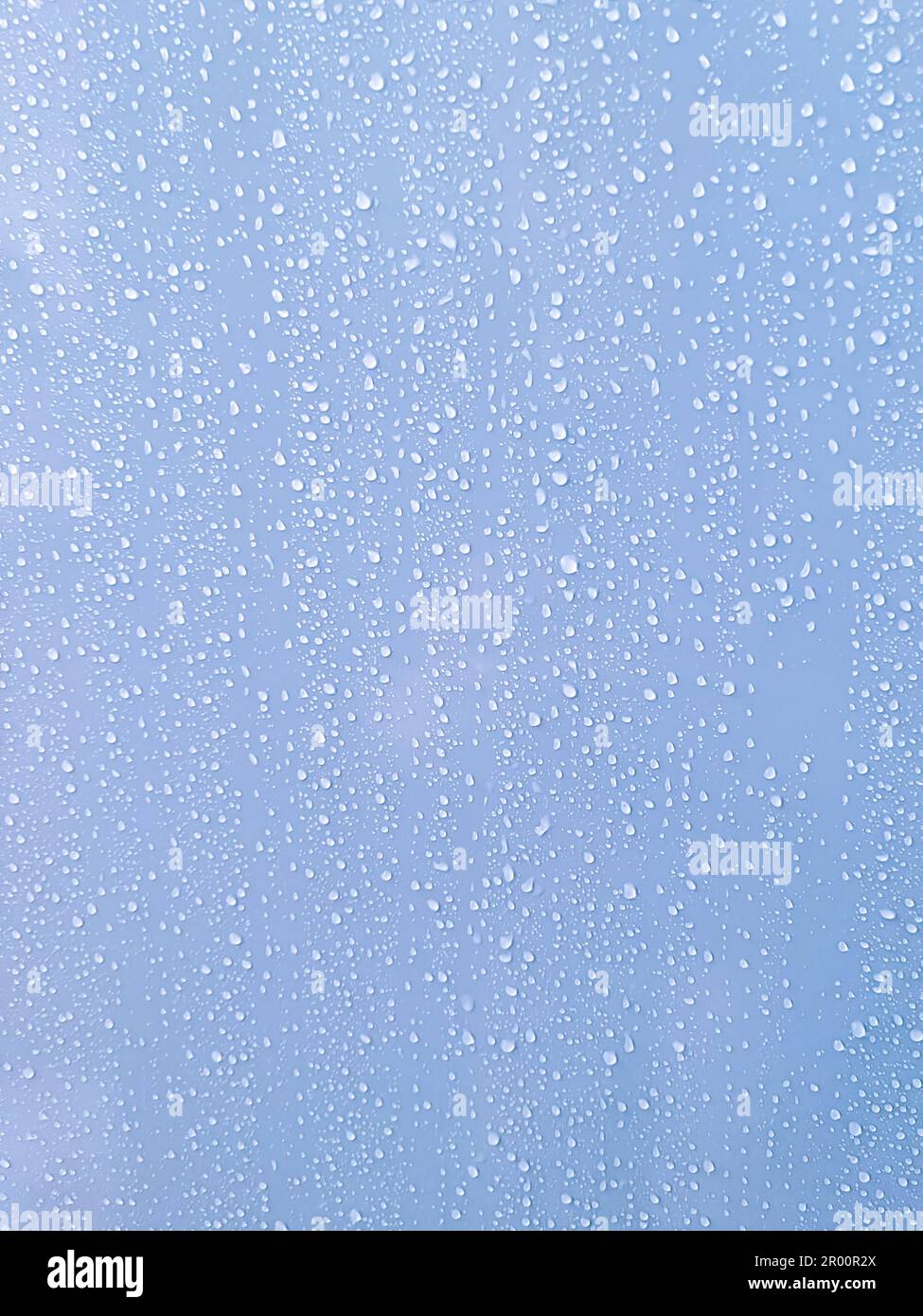 Close up abstract texture background of water droplets on a smooth shower wall surface Stock Photo