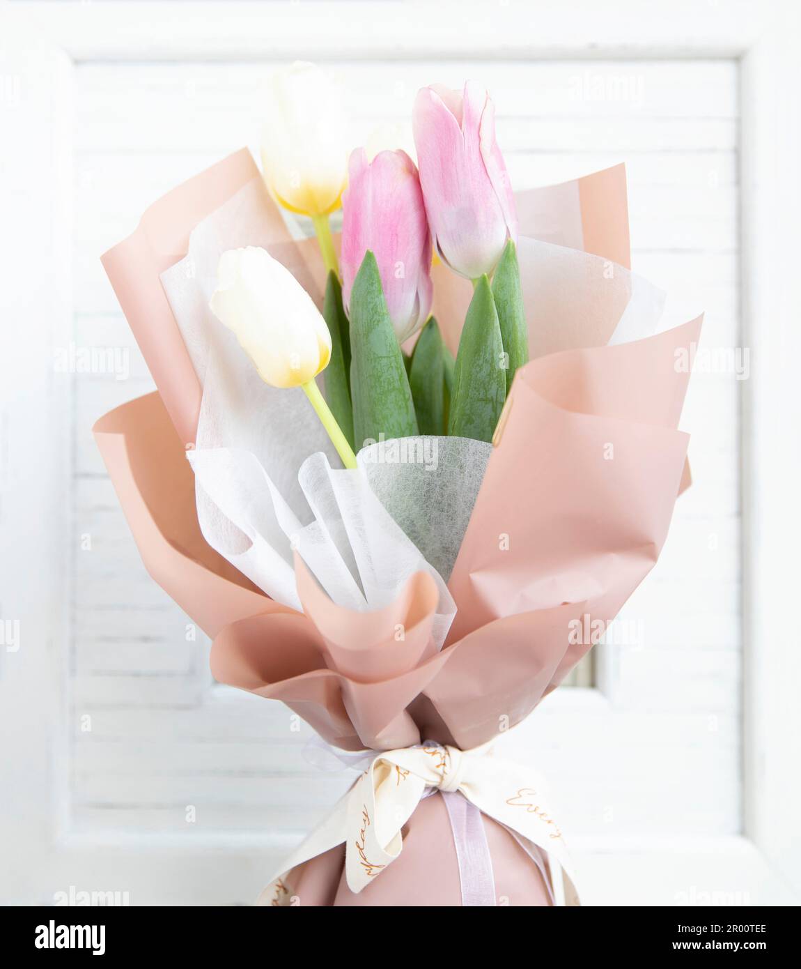 Bouquet of tulip over white wooden frame. Stock Photo