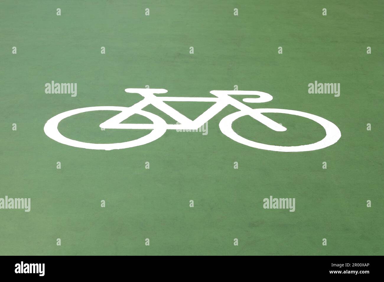 A bicycle symbol on green floor. Stock Photo