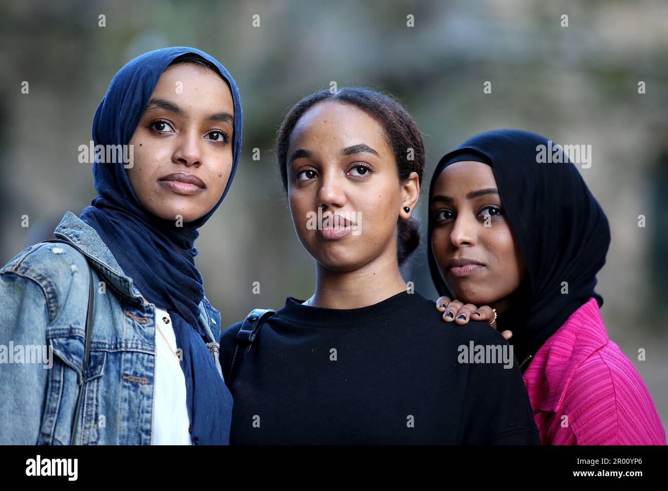 Sudanese friends (L-R) Rihab Ibrahim (28), Sara Yasir (25) and Fatima  Yousif (23) in a rally for peace in Sudan in Sydney, Saturday, May 6, 2023.  Members of the Sydney Sudanese community,