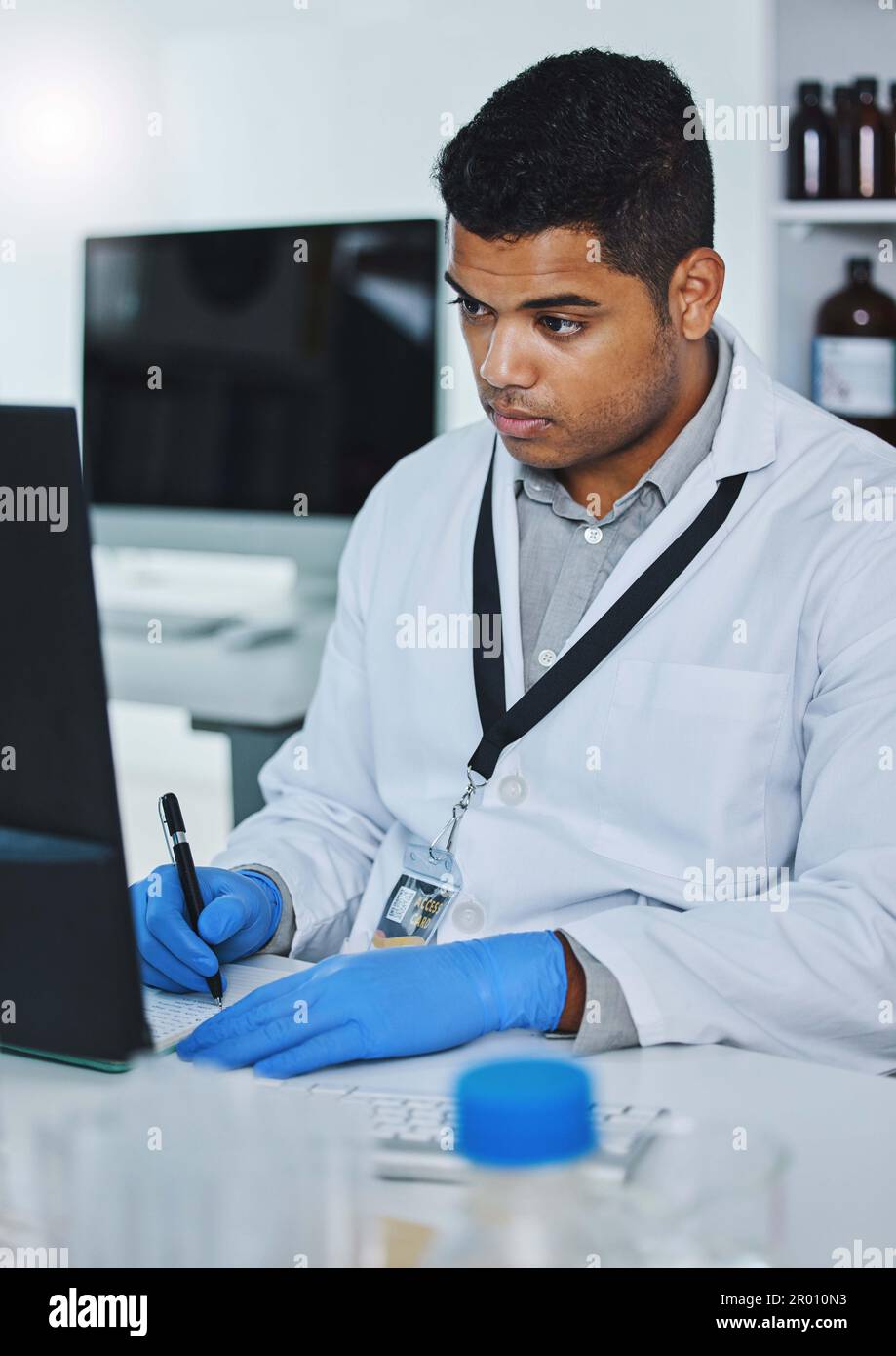 What does the data say. a young male researcher using a computer while