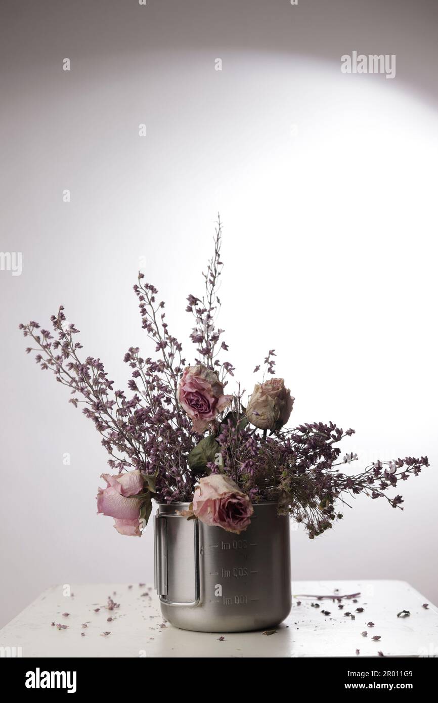 METAL CONTAINER WITH ROSES AND DRIED FLOWERS Stock Photo - Alamy