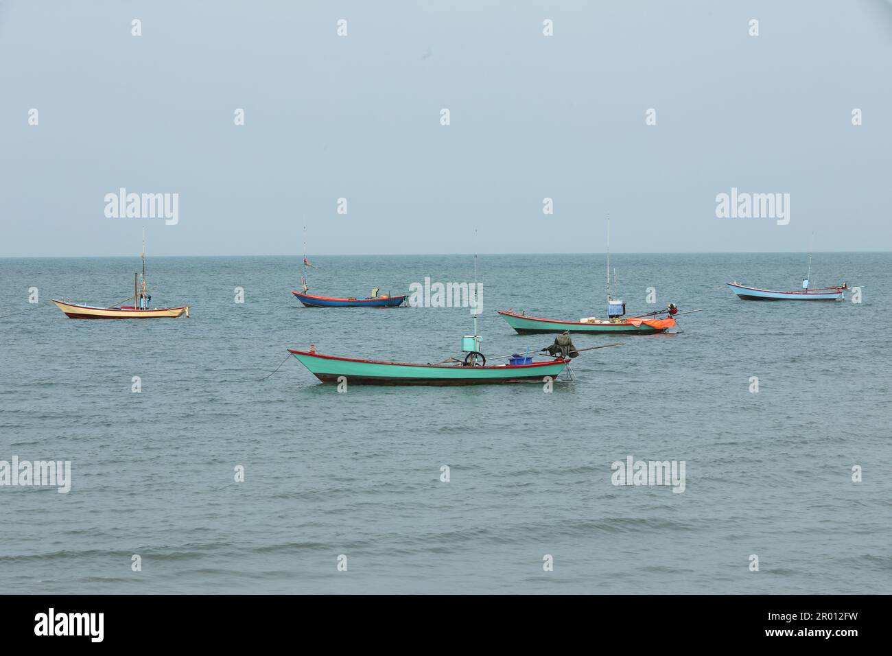 Row of fishing boat floating on the sea. Stock Photo