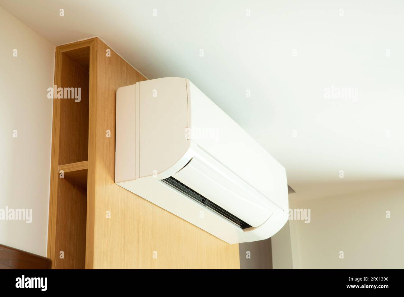 Split air conditioner installed on  wooden wall. Stock Photo