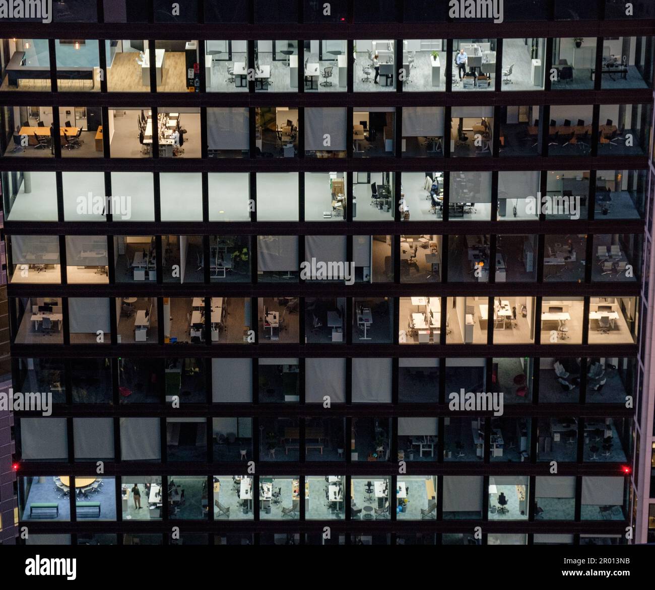 The office building at the late hour in the evening with multiple floors and glass windows in Germany, Europe Stock Photo