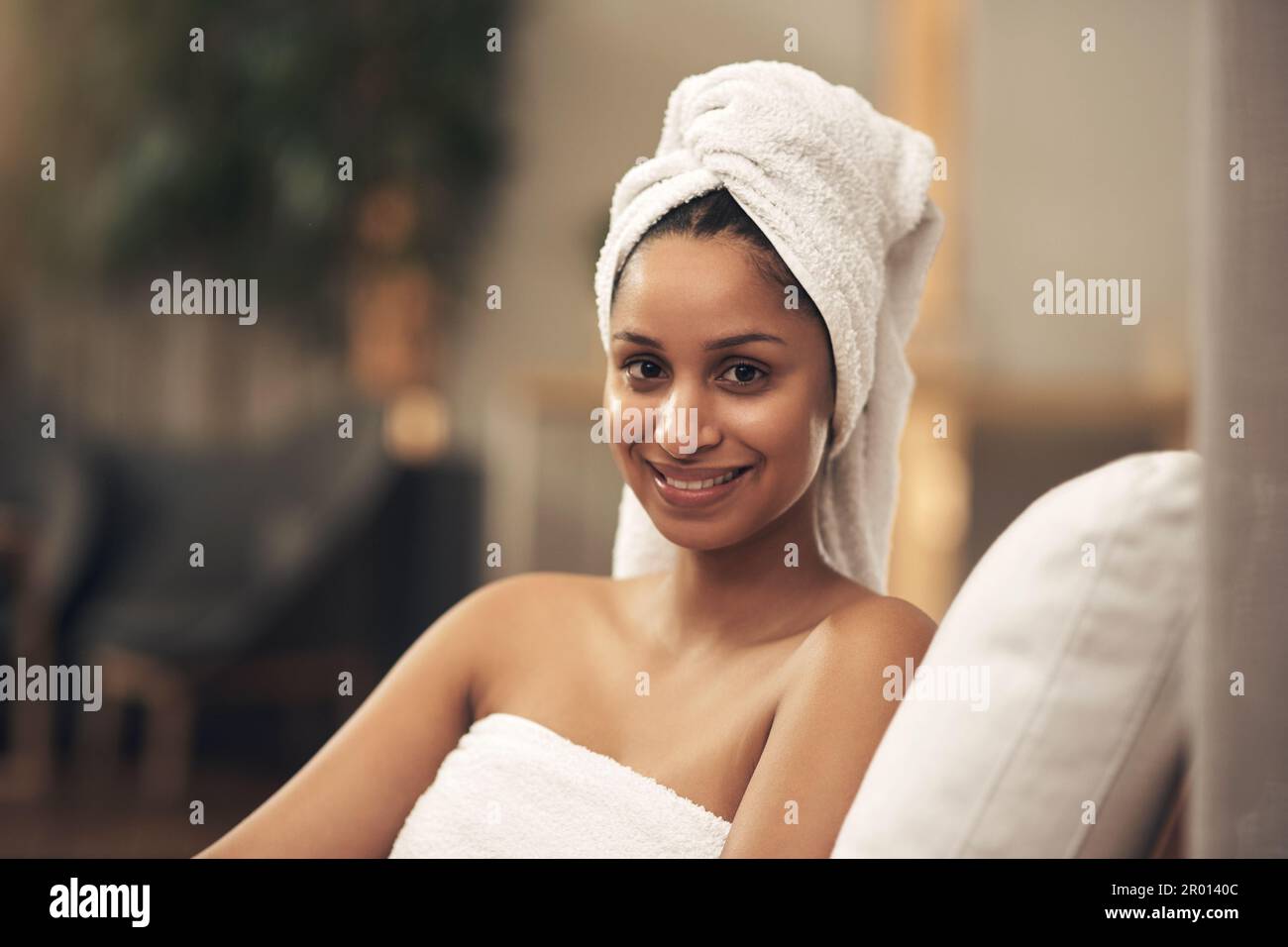 You shouldnt need an excuse to treat yourself to a spa day. a woman wearing a towel around her head while enjoying a spa day. Stock Photo