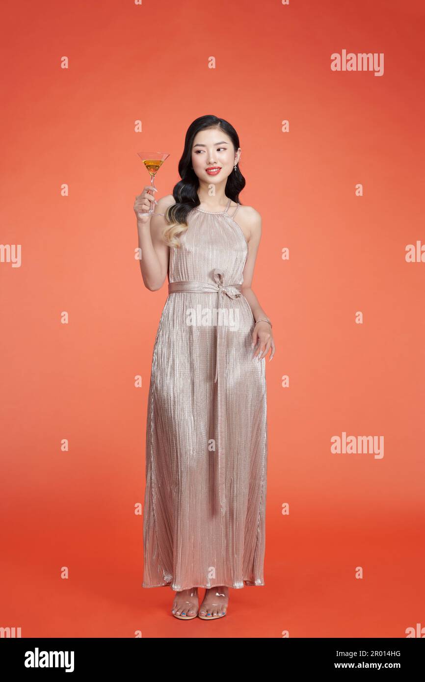 Beautiful young lady in glitter evening dress with wine glass in hand Stock  Photo - Alamy