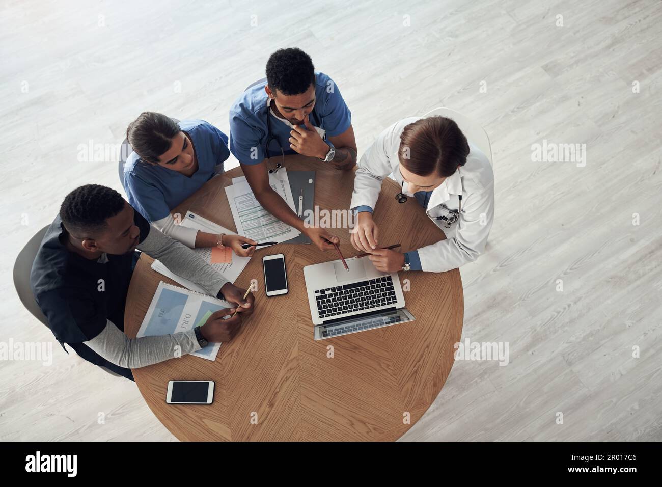 Together we will overcome. Shot a group of doctors discussing work matters in the office at work. Stock Photo