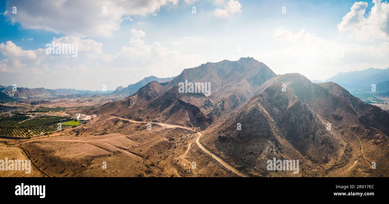 Hatta city welcoming sign written with large letters placed in Hajar mountains in Hatta enclave of Dubai in the United Arab Emirates aerial view Stock Photo