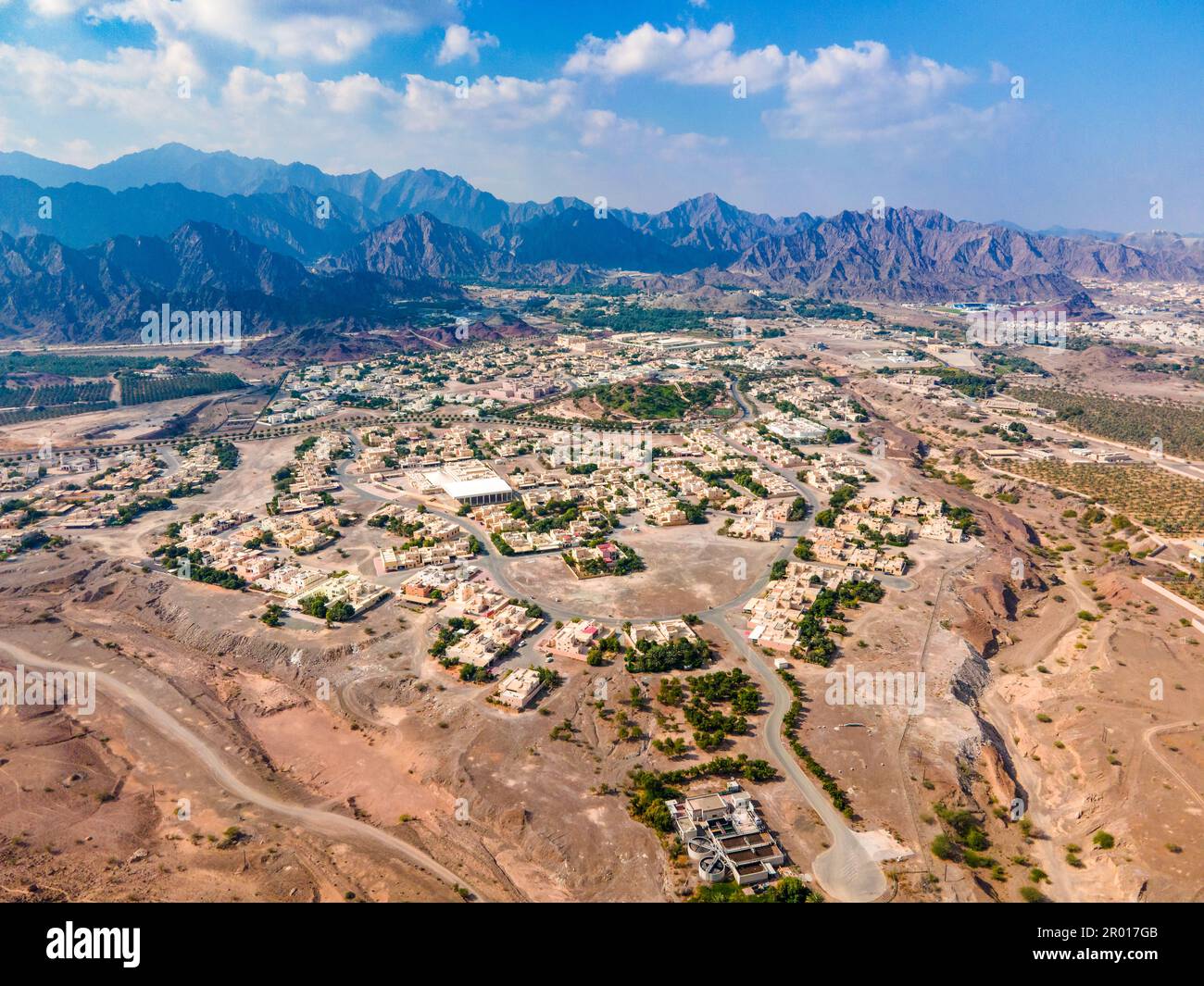 Hatta town aerial cityscape surrounded by Hajar mountains in Hatta enclave of Dubai in the United Arab Emirates aerial view Stock Photo