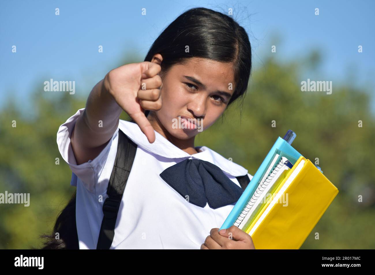 Youthful Diverse Female Student With Thumbs Down Stock Photo - Alamy