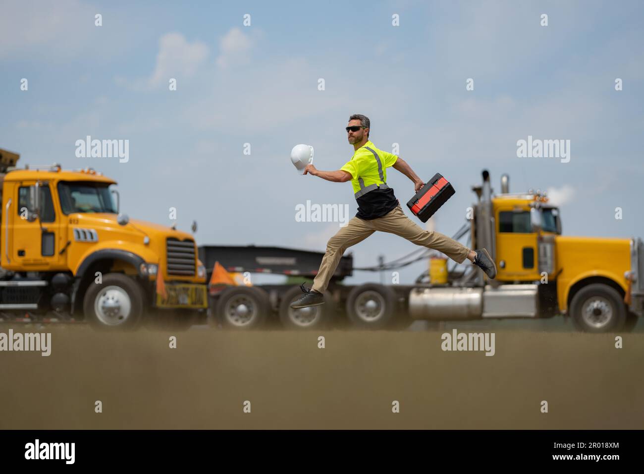 Middle aged builder excited jump on site construction. Excited builder ...