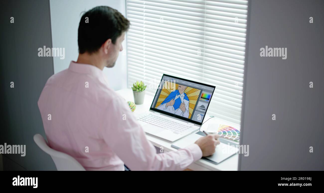 Male Designer Using Graphic Tablet While Working On Computer Stock Photo