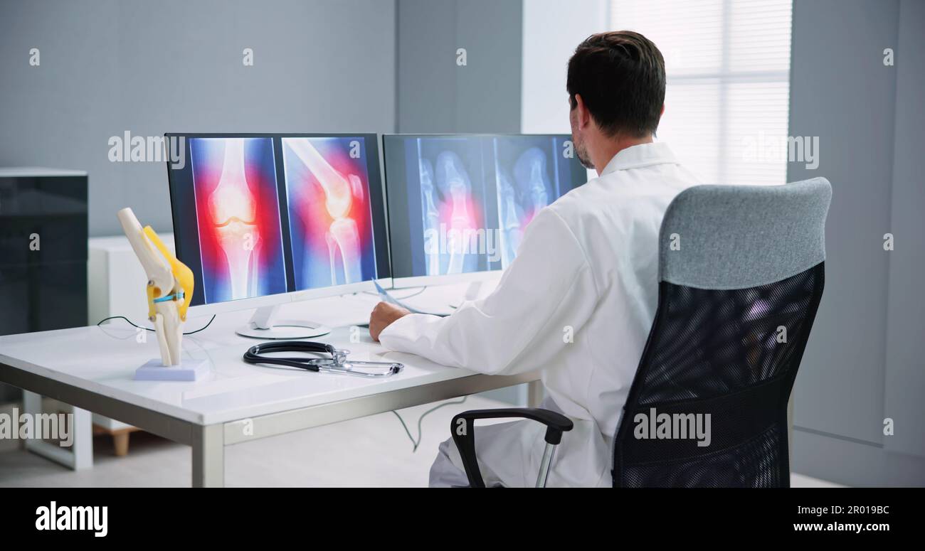 Dentist Using Computer Technology Dental Software For Teeth Xray Stock Photo