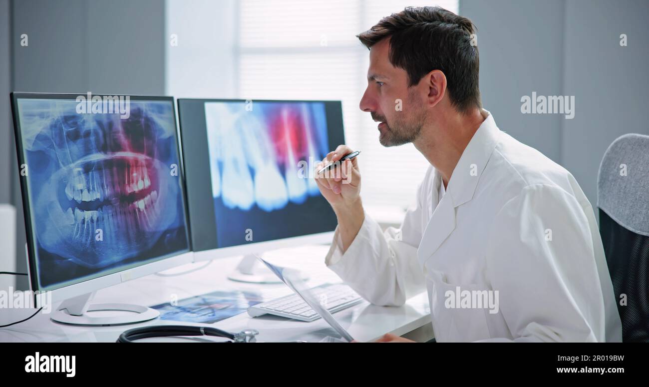 Radiologist Dentist Using X Ray Software On Desktop Computer Stock