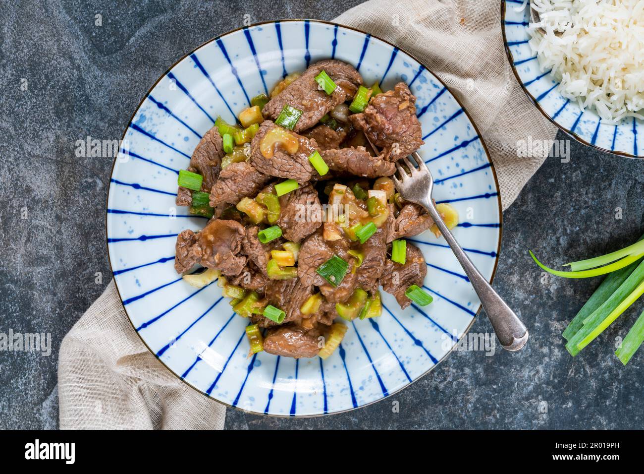 Steak and celery stir fry with rice Stock Photo Alamy