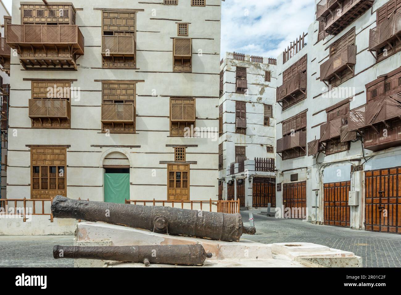 Al-Balad old town with traditional muslim houses and old cannons in the foreground, Jeddah, Saudi Arabia Stock Photo