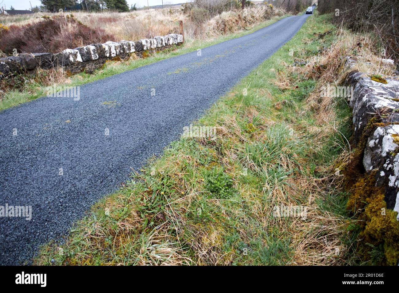 resurfaced rough tarmac road over bridge raised up in rural county donegal republic of ireland Stock Photo