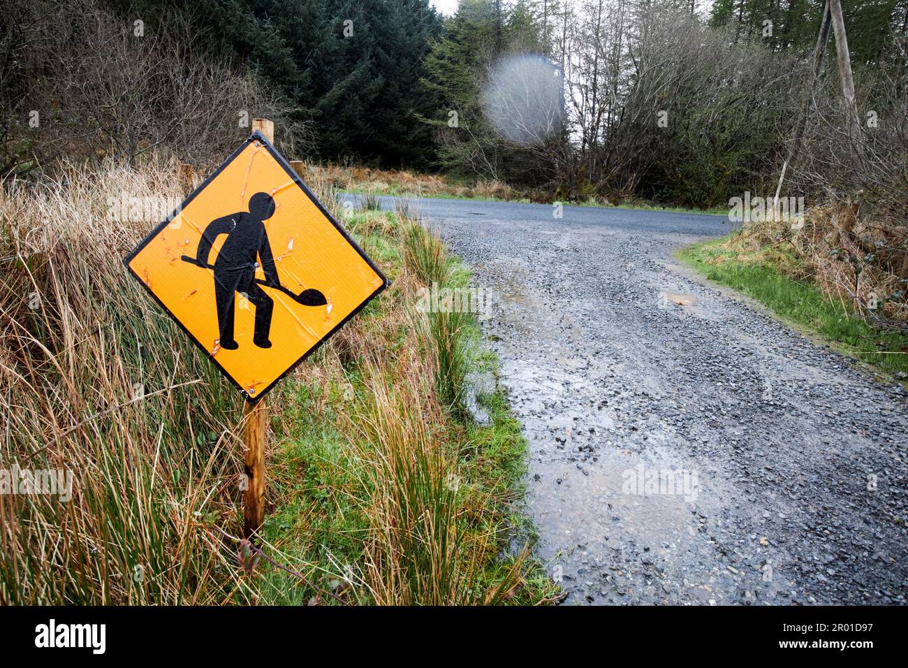 roadworks sign on rough country track in remote area of county donegal in rain republic of ireland Stock Photo