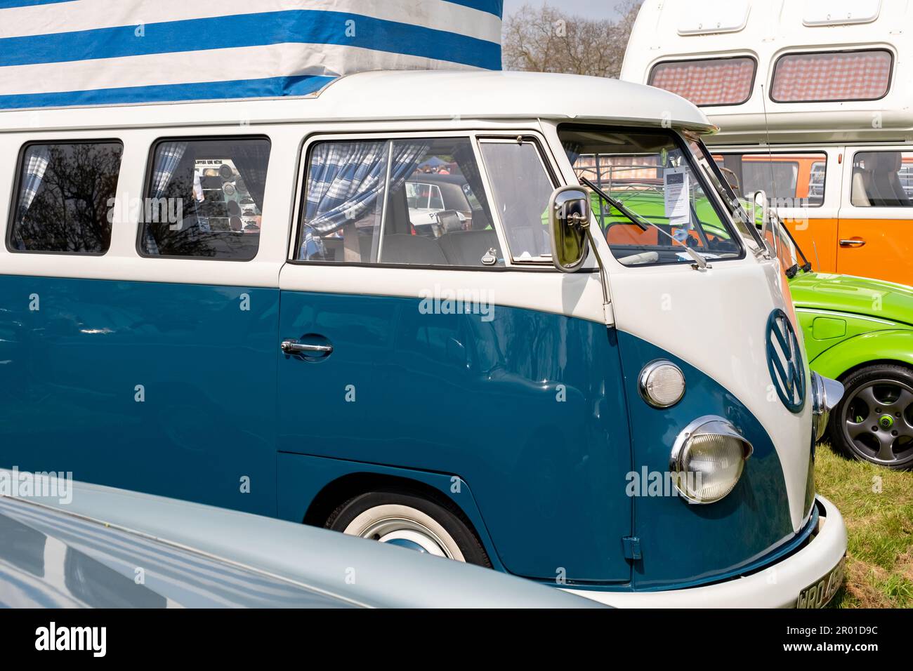 Earsham, Norfolk, UK – April 30 2023. Side on view of a fully restored classic split screen VW campervan on display at a small and local car show Stock Photo